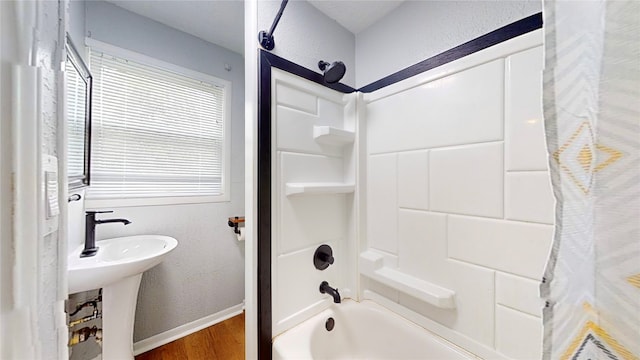 bathroom with shower / bath combination with curtain and wood-type flooring