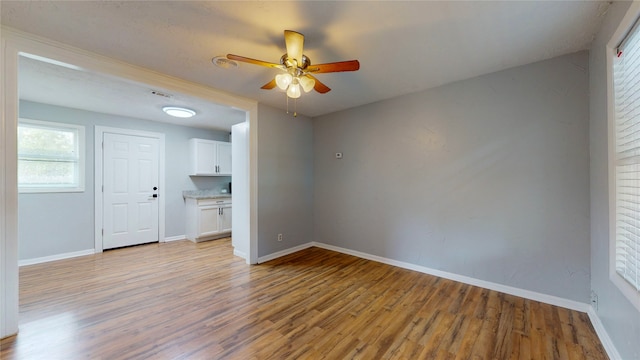 spare room featuring light hardwood / wood-style flooring and ceiling fan