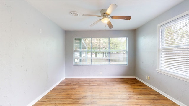 spare room with light hardwood / wood-style flooring and ceiling fan