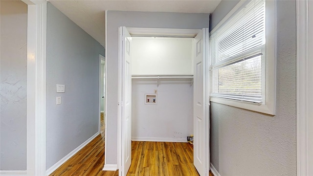 washroom with hookup for a washing machine and hardwood / wood-style flooring