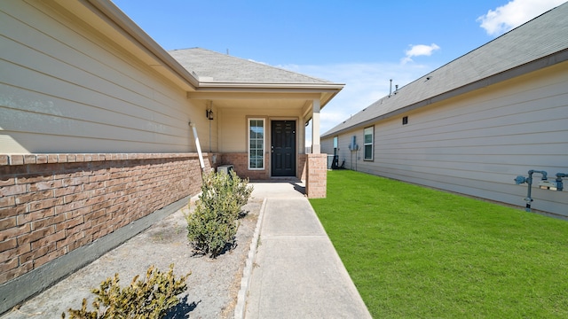 doorway to property with a yard