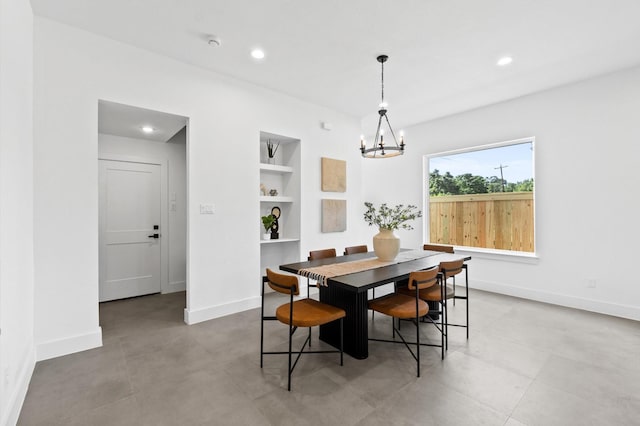 dining space featuring built in shelves, recessed lighting, baseboards, and an inviting chandelier