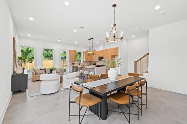 dining room with baseboards, visible vents, stairs, a notable chandelier, and recessed lighting