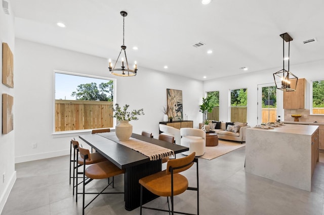 dining room featuring recessed lighting, visible vents, and a notable chandelier