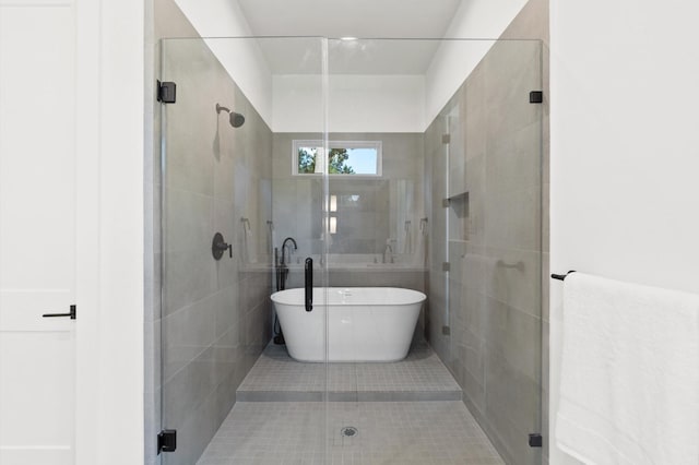full bath with a soaking tub and a shower stall