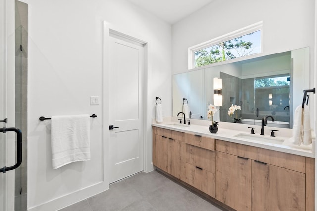 full bathroom featuring double vanity, tile patterned flooring, a shower stall, and a sink