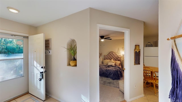 entryway with light tile patterned floors and ceiling fan