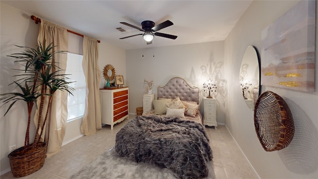 tiled bedroom featuring ceiling fan