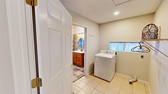 laundry area with washer / dryer, sink, and light tile patterned floors