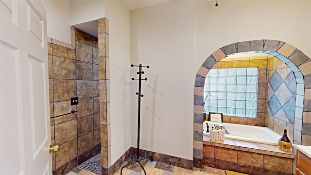 bathroom featuring independent shower and bath and vanity