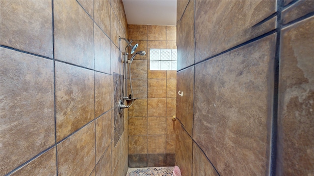 bathroom with a tile shower