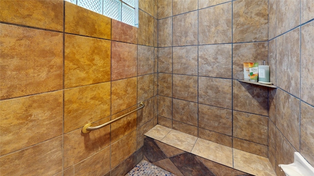 interior details featuring a tile shower