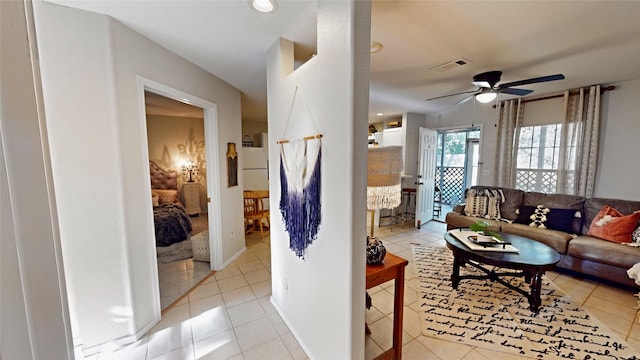 tiled living room featuring ceiling fan