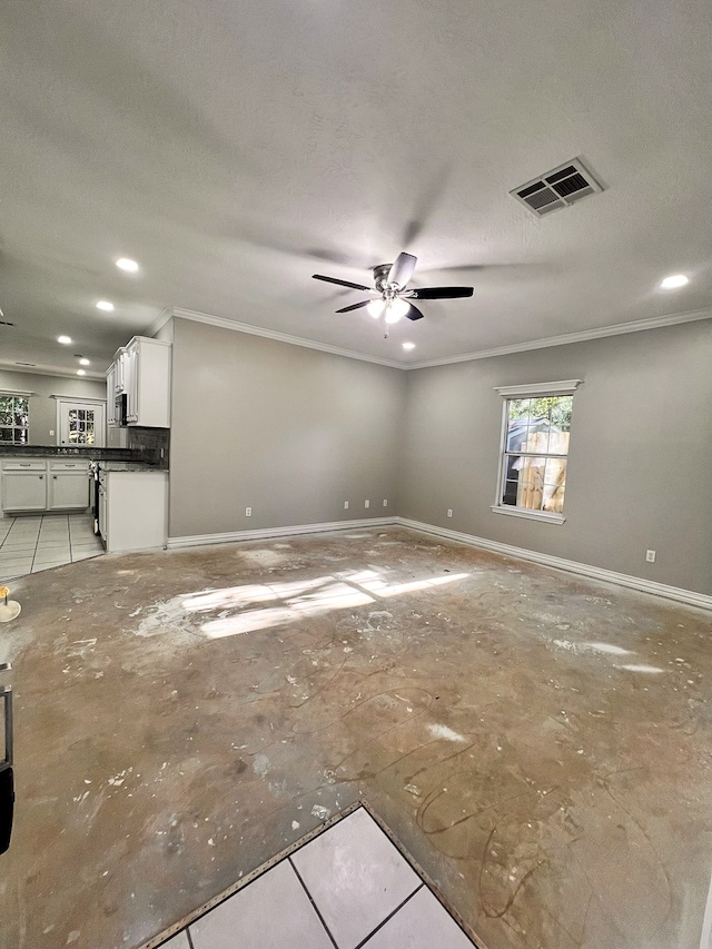 unfurnished living room with ceiling fan, a textured ceiling, and ornamental molding