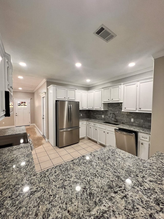 kitchen with white cabinets, dark stone countertops, sink, and appliances with stainless steel finishes