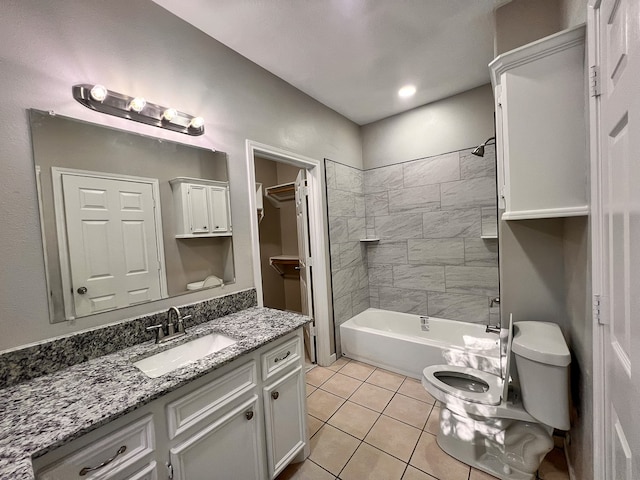 full bathroom featuring tile patterned flooring, vanity, toilet, and tiled shower / bath