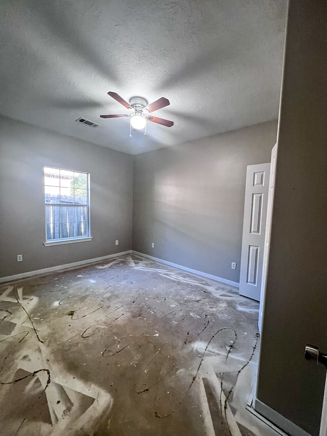 spare room featuring a textured ceiling and ceiling fan