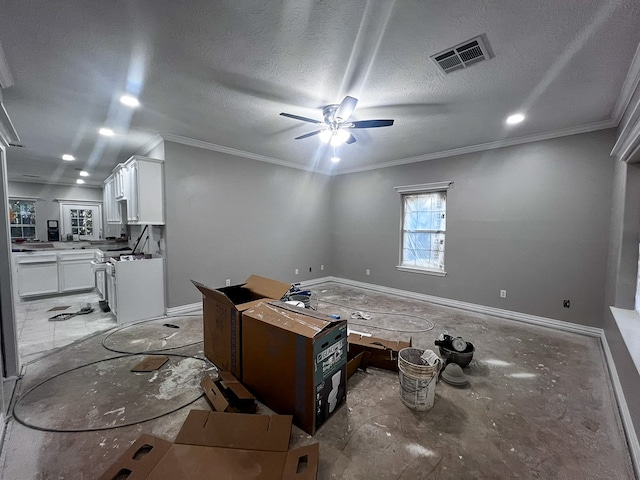 interior space featuring ceiling fan, crown molding, and a textured ceiling