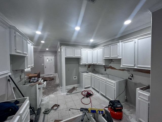 kitchen with white cabinetry and crown molding