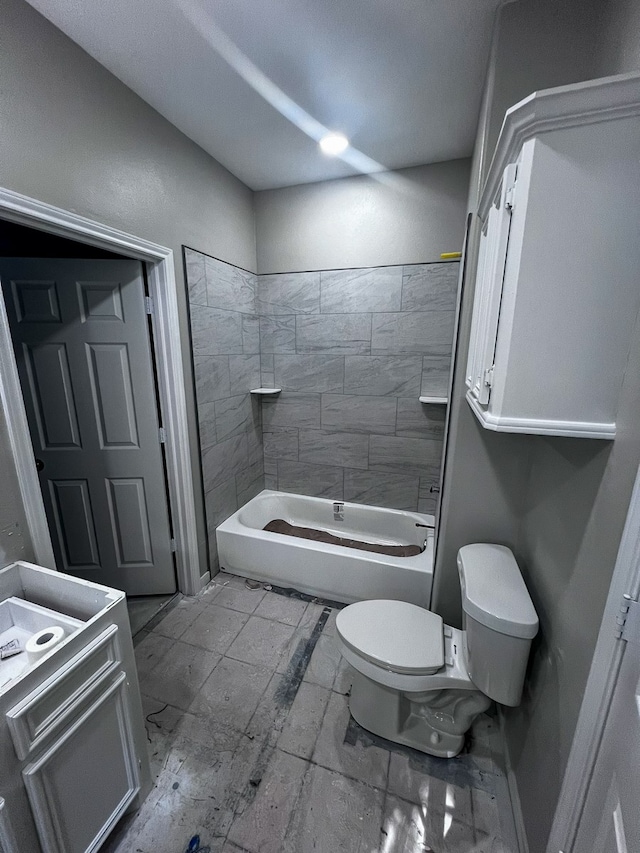 full bathroom with toilet, vanity, and tiled shower / bath