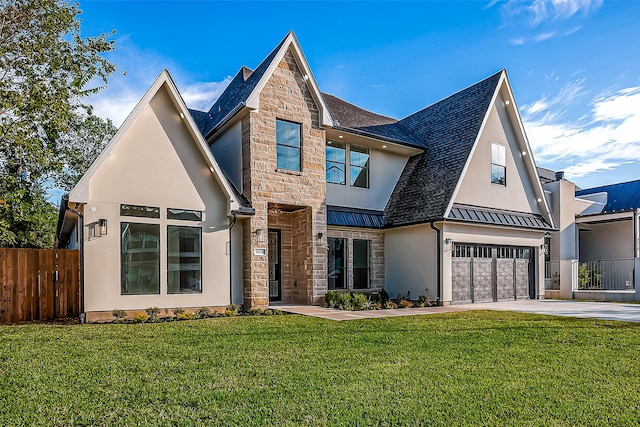 view of front of house featuring metal roof, fence, stone siding, a standing seam roof, and a front yard