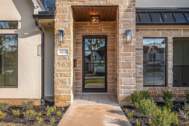 entrance to property featuring stone siding