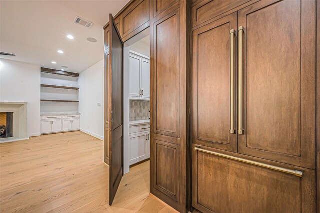 corridor featuring light wood-style floors, recessed lighting, baseboards, and visible vents
