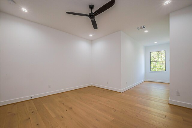 spare room with a ceiling fan, visible vents, light wood-type flooring, baseboards, and recessed lighting