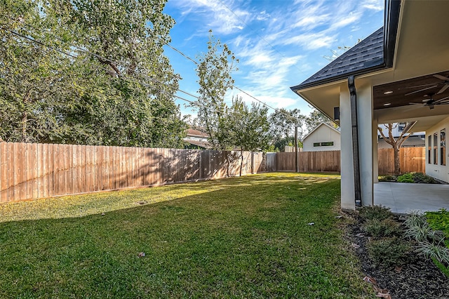 view of yard with ceiling fan and a patio area