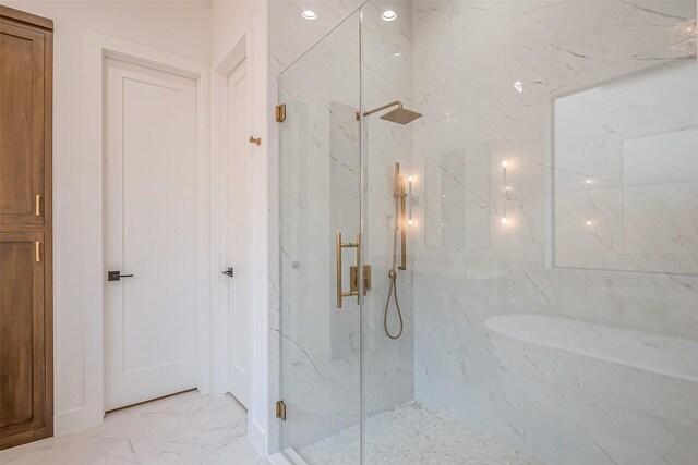 bathroom featuring a marble finish shower and marble finish floor