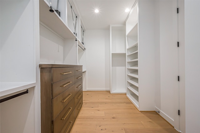 walk in closet featuring light hardwood / wood-style flooring