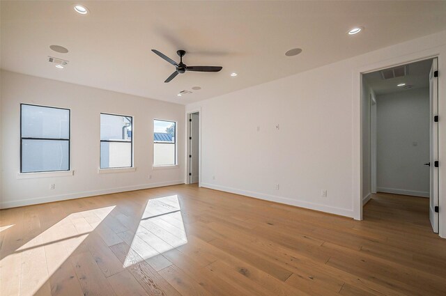 empty room with ceiling fan, visible vents, baseboards, light wood-style floors, and recessed lighting