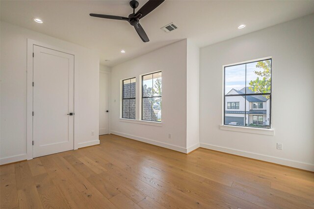 unfurnished bedroom with recessed lighting, multiple windows, and light wood finished floors