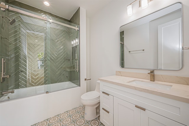 full bathroom with toilet, enclosed tub / shower combo, and vanity