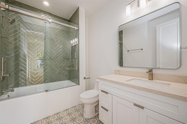 bathroom with recessed lighting, combined bath / shower with glass door, toilet, and vanity