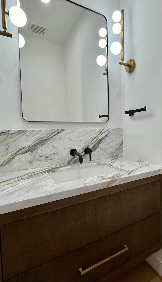 bathroom with vanity and backsplash