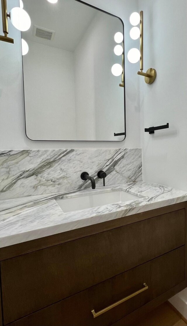 bathroom with visible vents and vanity