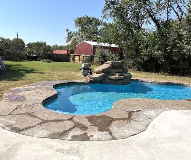 view of swimming pool with a yard and a patio area