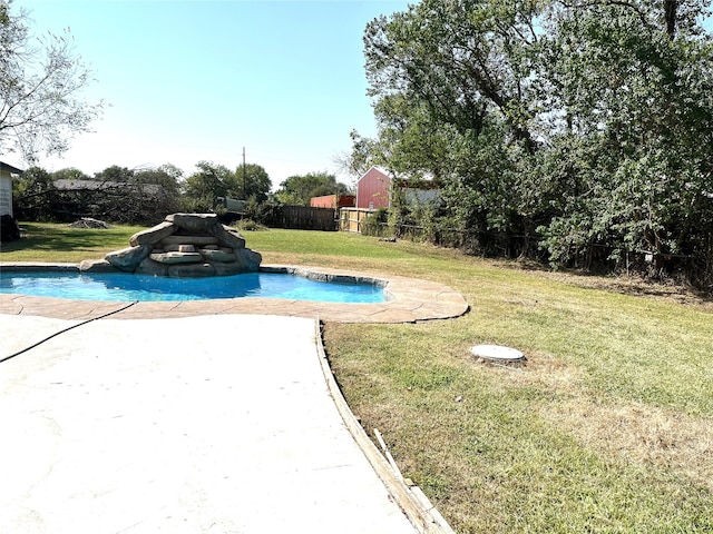 view of swimming pool featuring a yard and a patio area