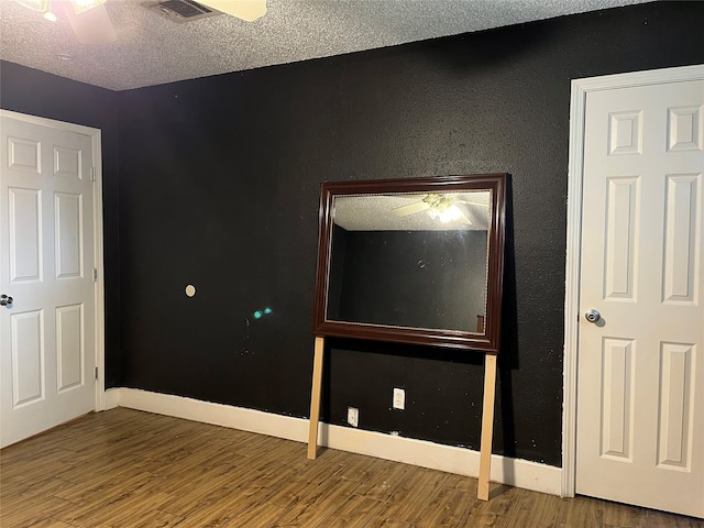 unfurnished bedroom featuring hardwood / wood-style flooring and a textured ceiling