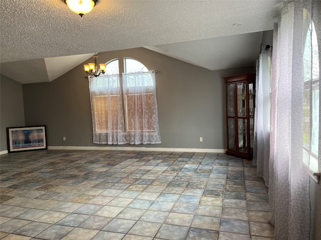 unfurnished dining area featuring vaulted ceiling, a notable chandelier, and a textured ceiling