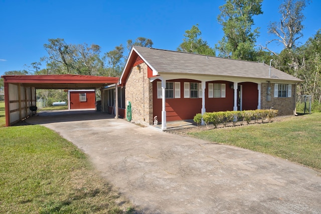 view of front of property with a front yard and a carport