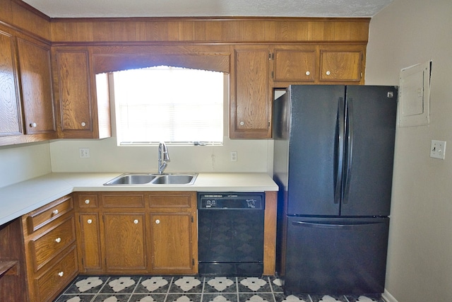 kitchen featuring a textured ceiling, black appliances, and sink