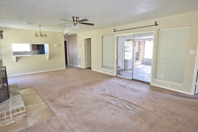 unfurnished living room featuring a textured ceiling, carpet flooring, and ceiling fan with notable chandelier