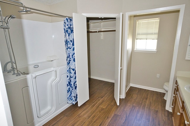 bathroom featuring vanity, hardwood / wood-style flooring, and toilet