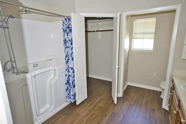 6823 County Road 659, Brazoria, TX 77422 - bathroom featuring vanity, wood finished floors, a shower with curtain, and a walk in closet