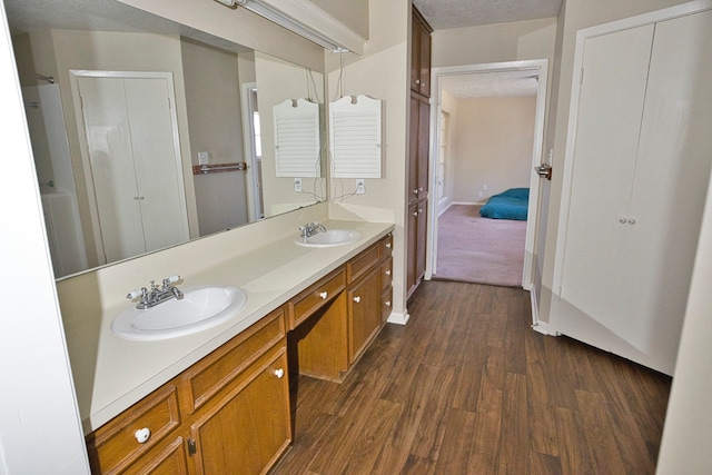 bathroom featuring vanity, hardwood / wood-style floors, and a textured ceiling