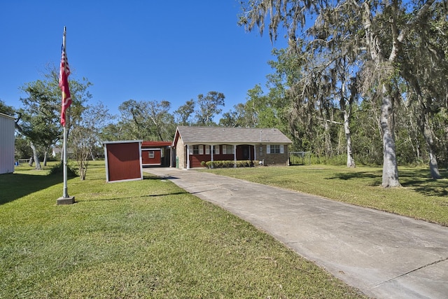 6823 County Road 659, Brazoria, TX 77422 - ranch-style home featuring concrete driveway, a front lawn, and a carport