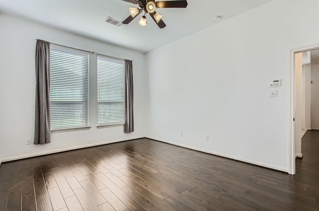 spare room featuring dark hardwood / wood-style floors and ceiling fan