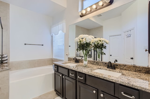 bathroom with vanity, a tub to relax in, and tile patterned floors